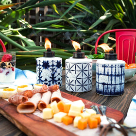 Group of TIKI tie-dye torches elevates garden ambiance.