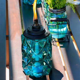 TIKI Topaz Blue tabletop torch for intimate outdoor gatherings.