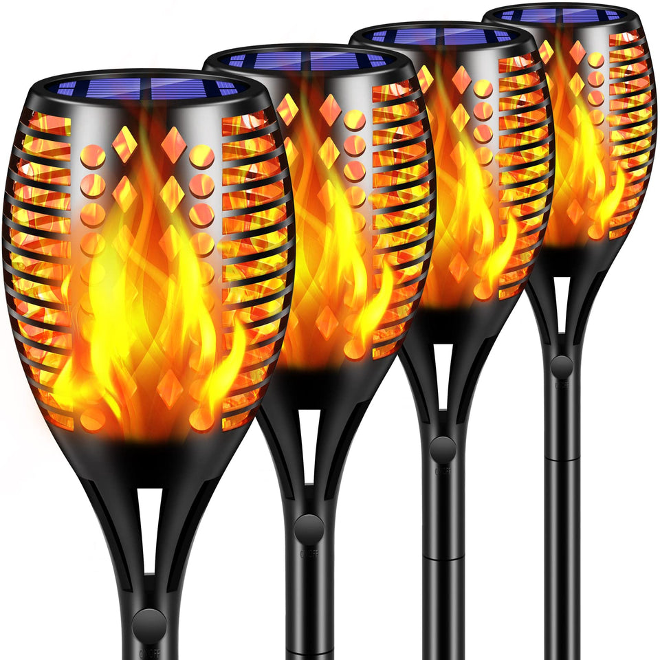 TomCare 43-inch flame torch lighting a garden pathway with warm glow.