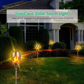 TomCare bronze solar flame torches in backyard ambience after sunset