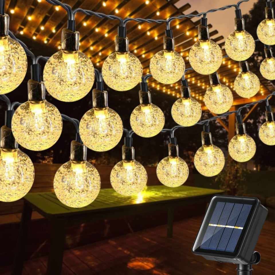 Toodour solar string lights with 100 LED globes illuminate outdoor spaces with warm, energy-efficient glow.