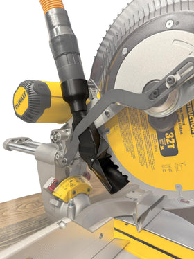Tooldapt dust port mounted on DeWalt DWS779/DWS780 showing secure dust capture at the cut line