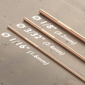 TOOLIOM ER70S-6 copper-coated TIG rod close-up, emphasizing smooth arc stability for clean welds.