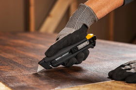 ToughBuilt heavy-duty cutting in cardboard and drywall—versatile tool on job sites.