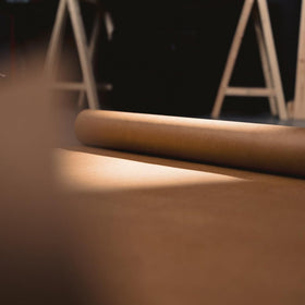 Roll of X-Paper protecting a concrete workspace during tasks.