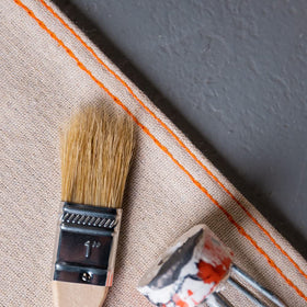 Project-ready setup using Trimaco Stay Put Canvas Plus drop cloth in home workshop