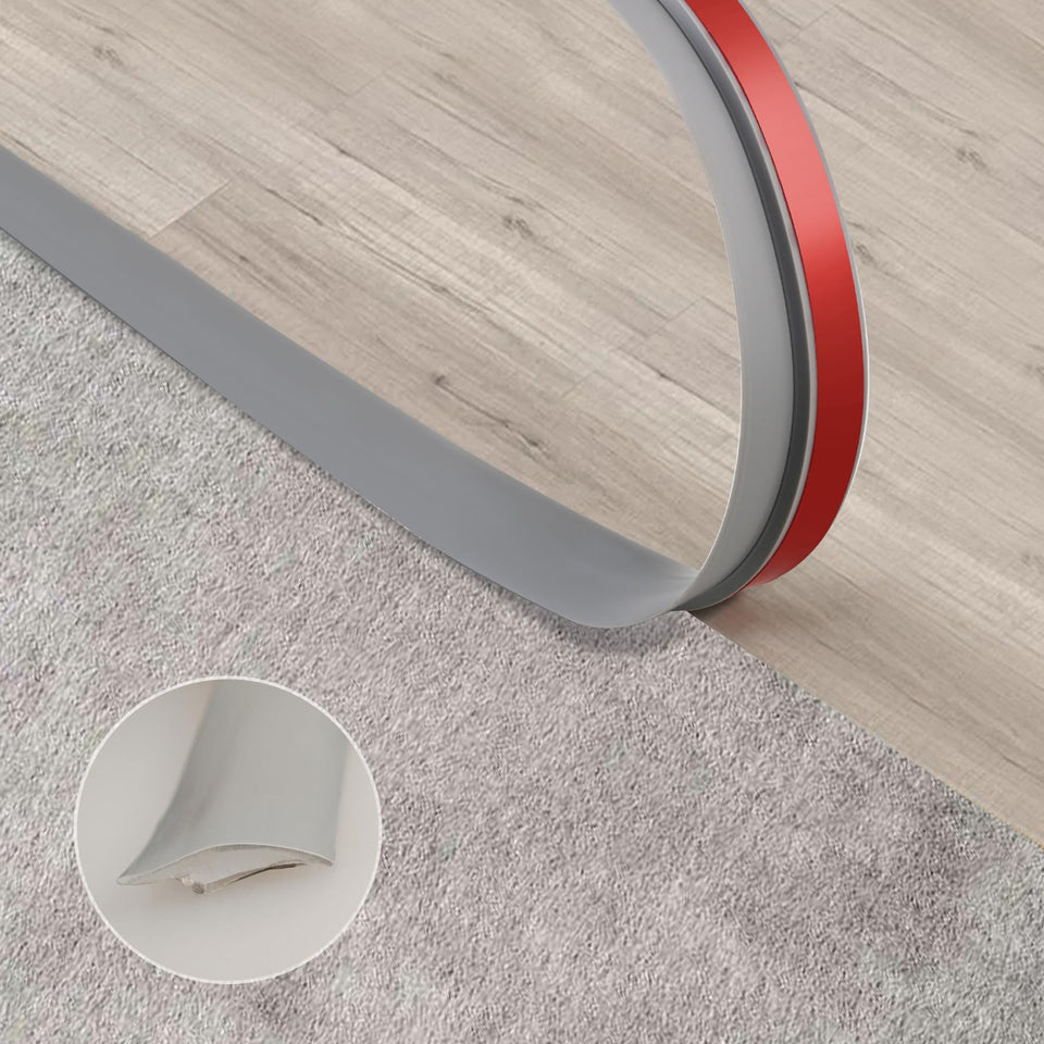Trimold carpet-to-tile grey threshold adhesive strip showing seamless transition.