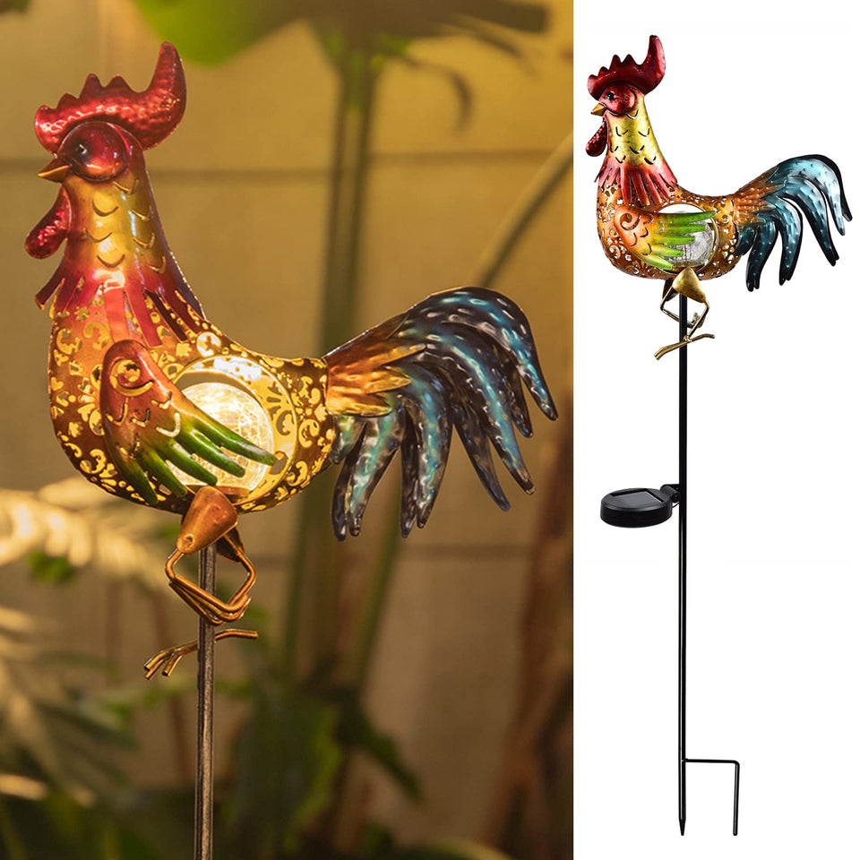 Tryme rooster solar light outdoor garden statue glows warmly at dusk.