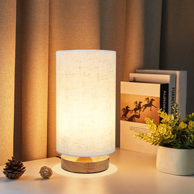 UCHENTON small bedside lamp with wood base adding warm ambience to bedrooms.