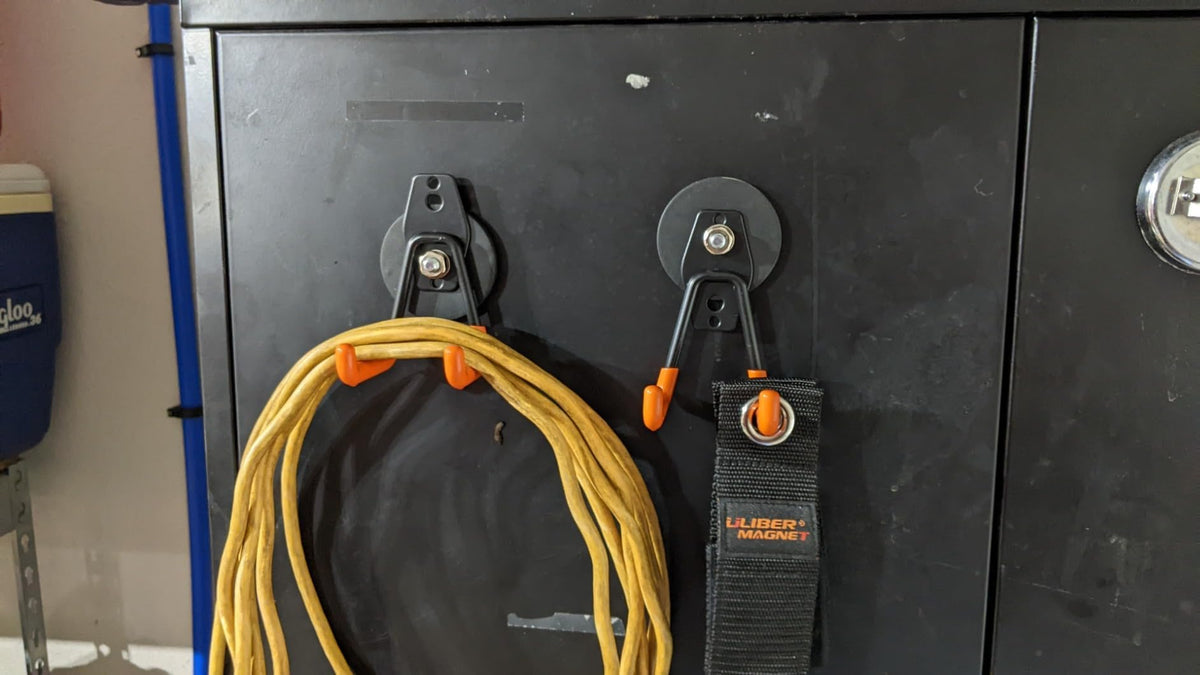 Broom and mop hung securely, saving floor space in a utility area.