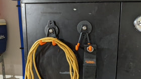 Broom and mop hung securely, saving floor space in a utility area.