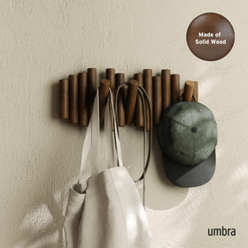 Umbra Picket five retractable wood pegs on a walnut-finished rack.