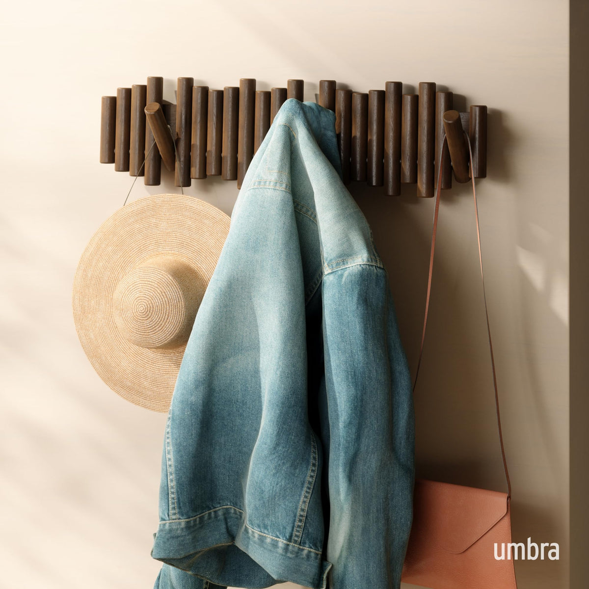 Umbra Picket wall-mounted wood hooks folded-down design saves space when not in use.