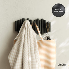 Umbra Picket wood peg fold-down design saves space when coats are not in use.