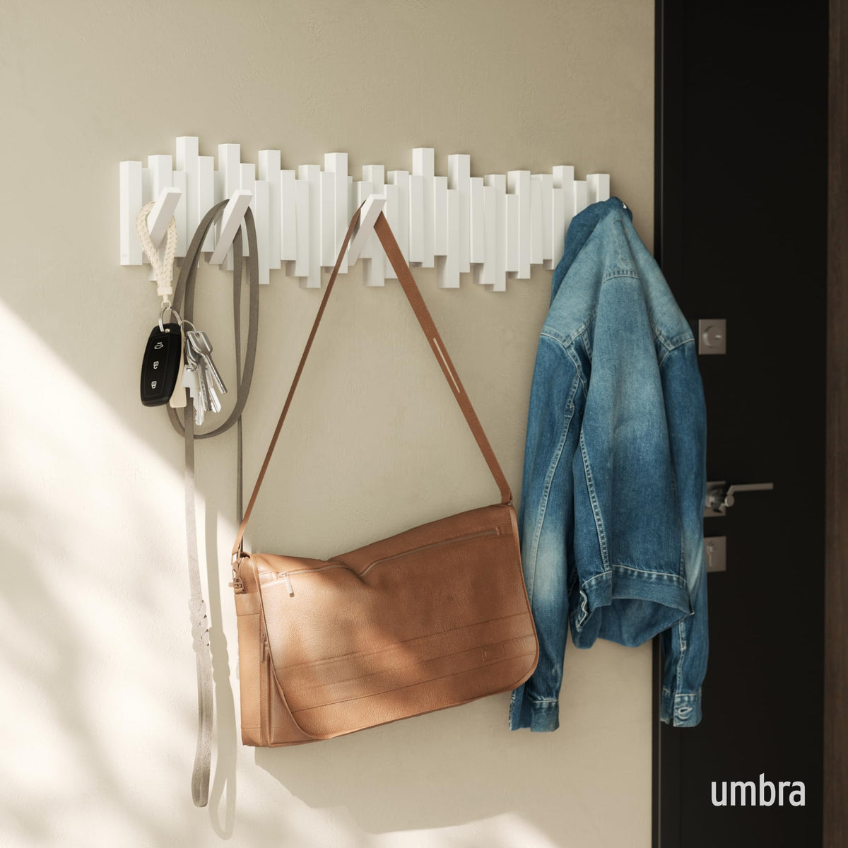Umbra Sticks artful modern design enhances decor while organizing coats and bags.