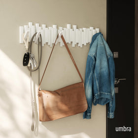 Umbra Sticks artful modern design enhances decor while organizing coats and bags.
