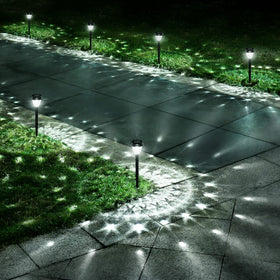 URAGO mandala-pattern solar light brightening walkway at dusk