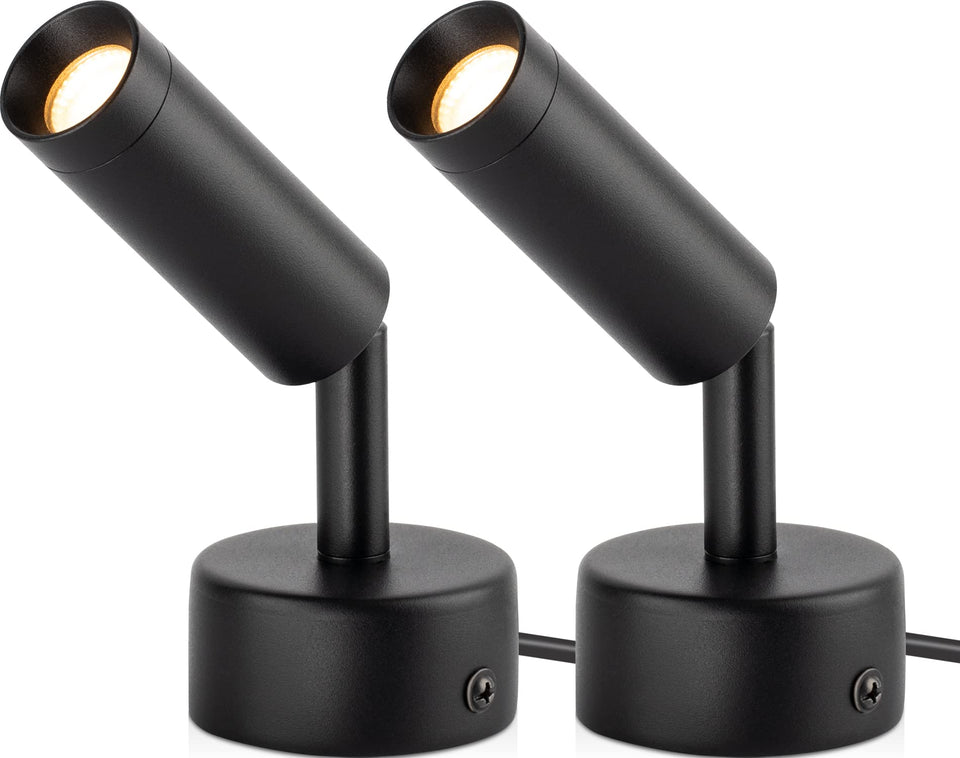 URTOM indoor spotlight highlights plants with warm white accent lighting.