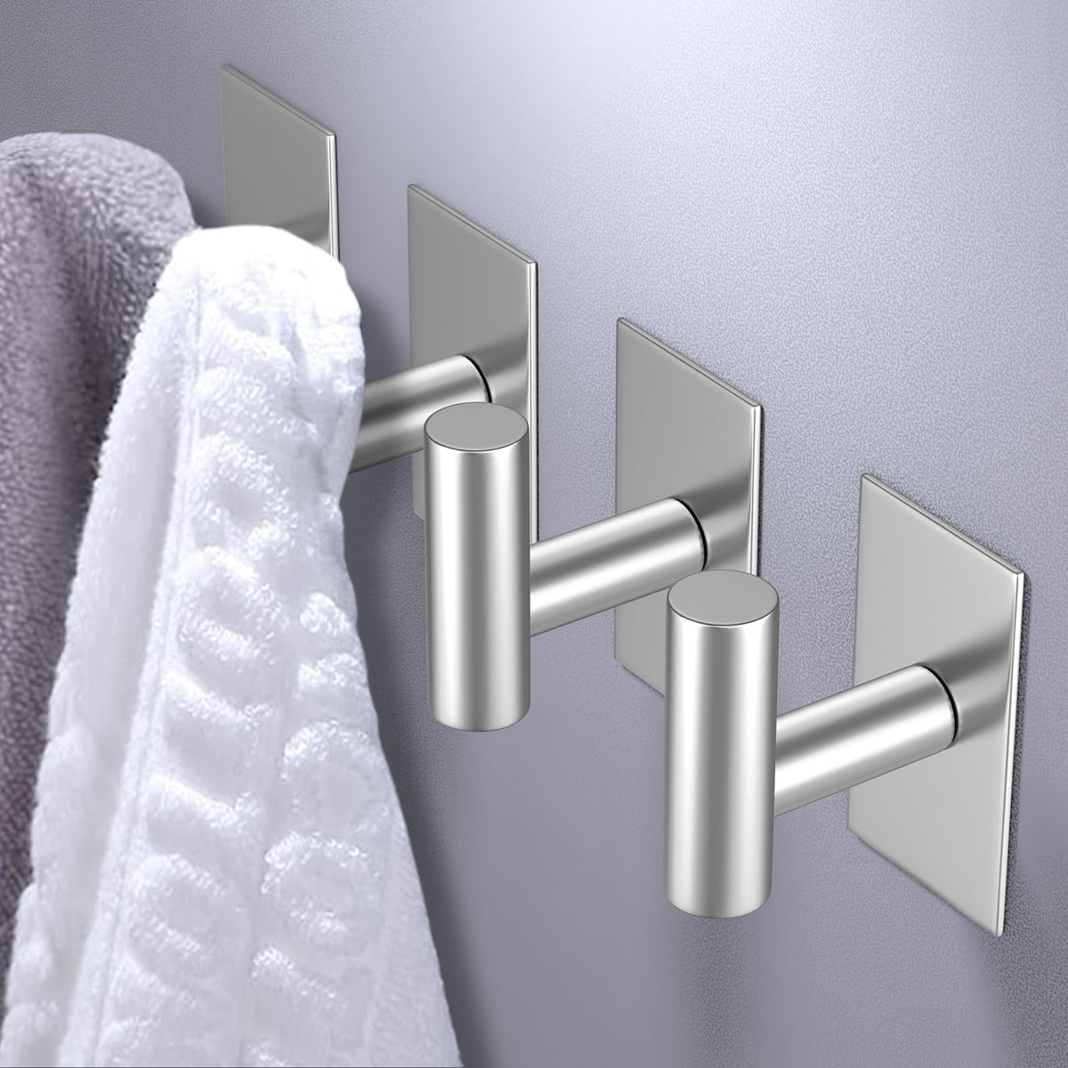 VAEHOLD adhesive hook installation close-up showing strong wall adhesion.