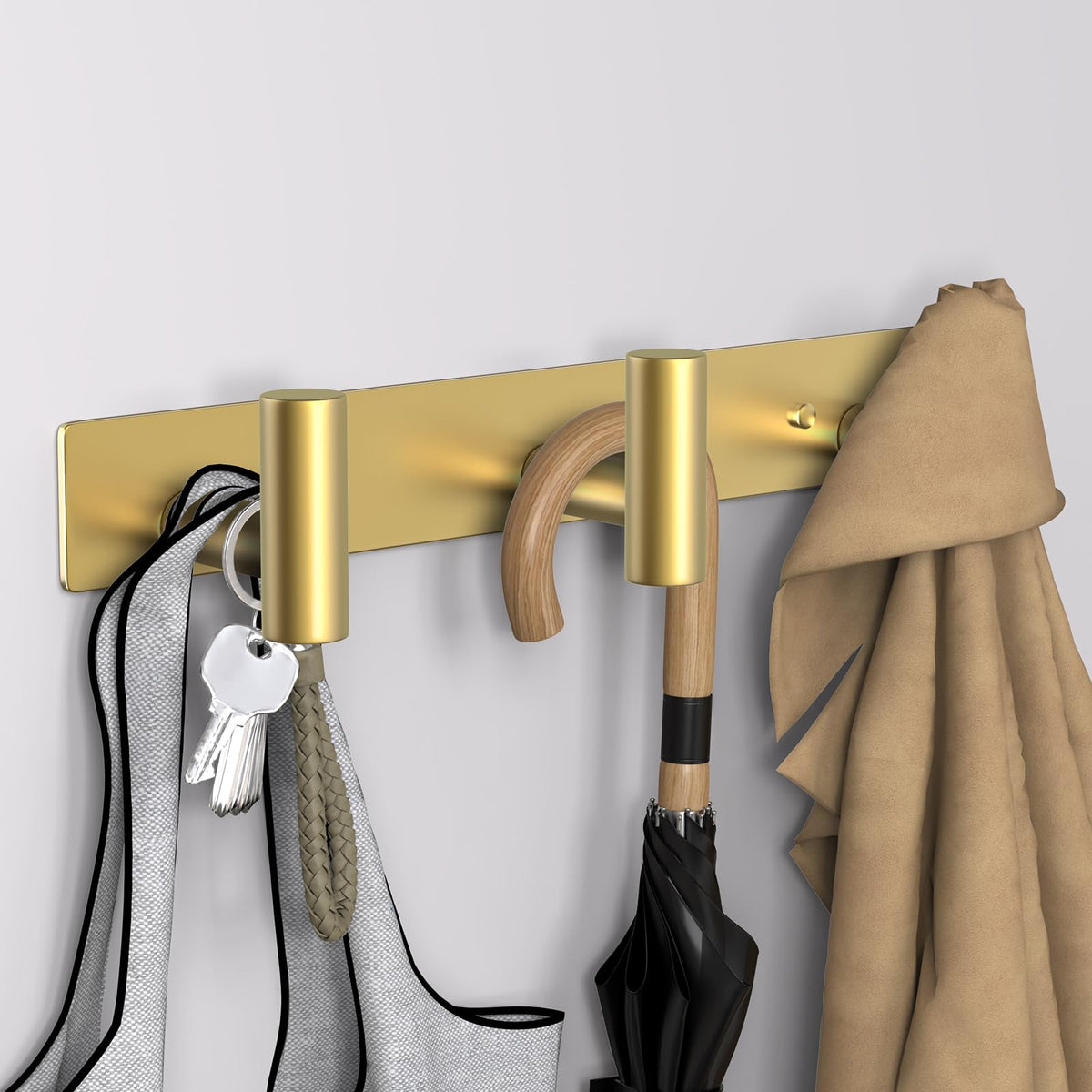 VAEHOLD gold T-shape wall mount in bathroom setting with towels