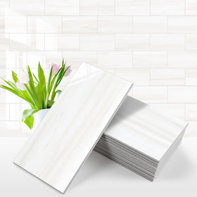 Vamos Tile glossy dolomite white pack shot; easy peel-and-stick setup.