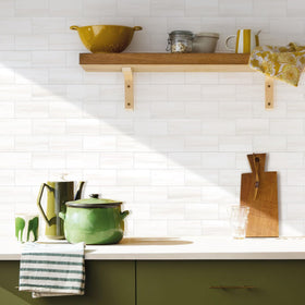 Vamos Tile white subway bathroom backsplash close-up; durable glossy finish.