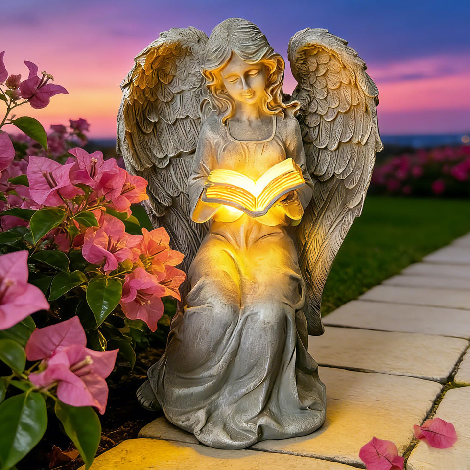 Vcdsoy solar angel statue side view with book enhancing outdoor ambiance.
