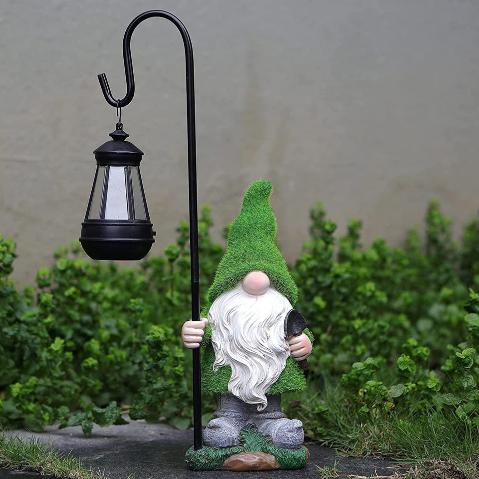 VChymm flocked garden gnome statue with solar LED light in yard.