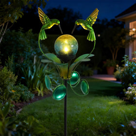 VCUTEKA crackle glass globe on bluebird stake glows softly at night.