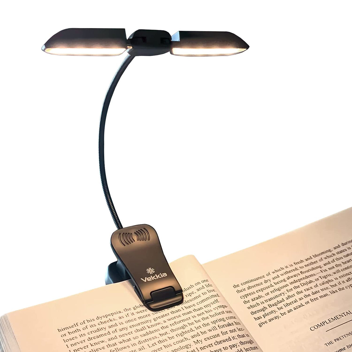 Vekkia book light clipped to a page for nighttime reading