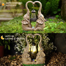 Vereemy playful elephant figures in grass with entwined trunks and lantern.