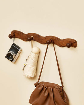 Vinoil decorative coat rack for bathroom storage of towels and robes.