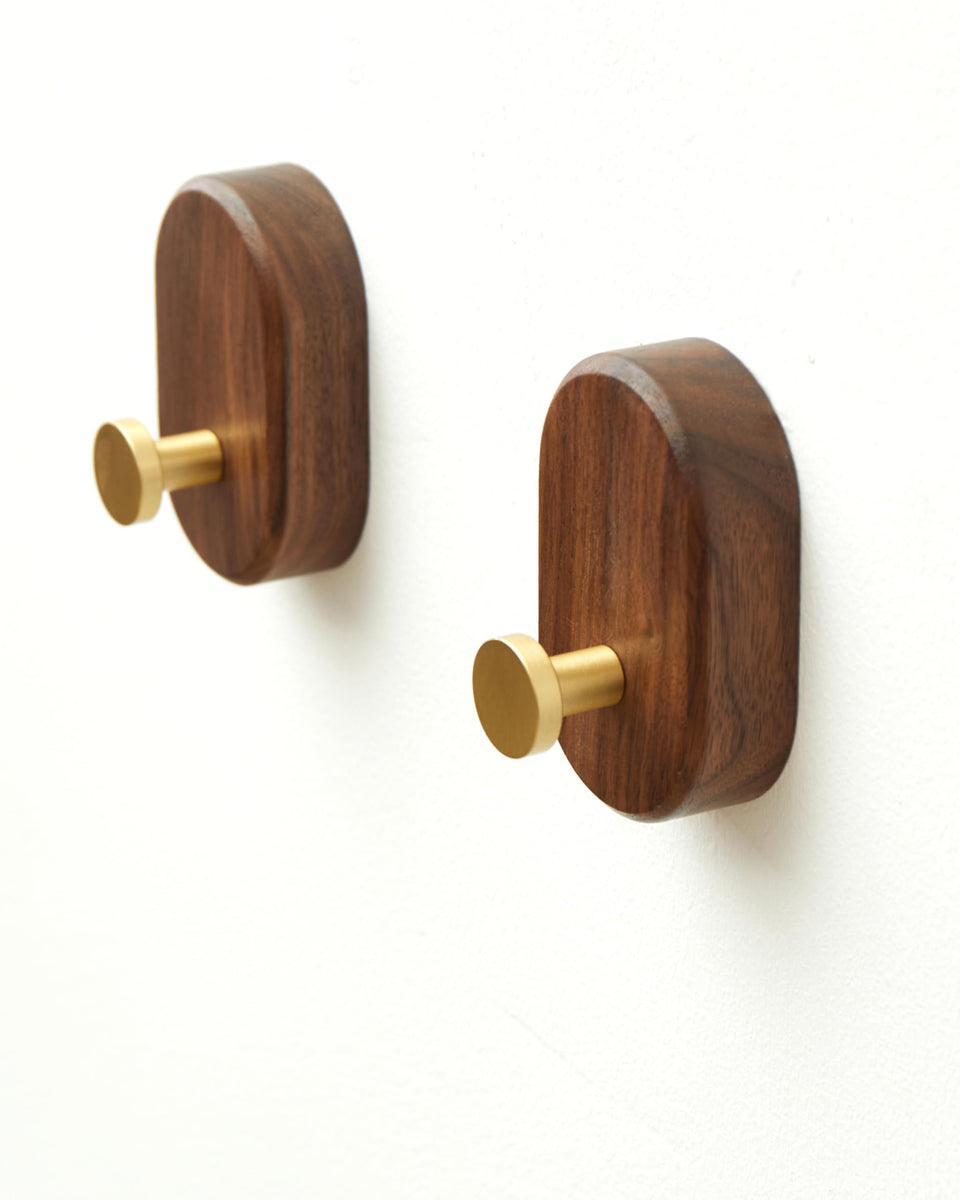 Vinoil walnut wood coat hook with brass accent for sturdy daily hanging.