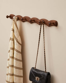 Vinoil walnut finish wall mounted coat rack ideal for jackets and bags.