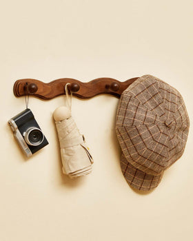 Vinoil wooden coat hooks for towels in bathroom or laundry area.