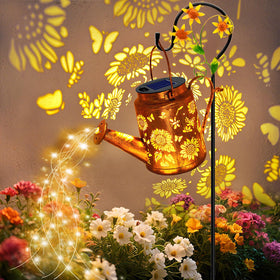 VOOKRY solar watering can light hanging over a sunlit garden for whimsical illumination.