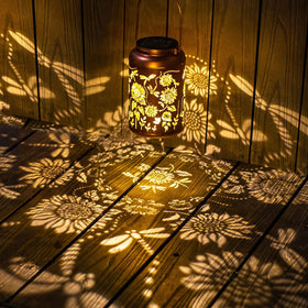 WACLSTDAY lantern with sunflower pattern casts decorative shadows on walls