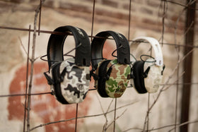 Walker's Ghost Duck Camo earmuff worn in field use for camouflage and comfort.