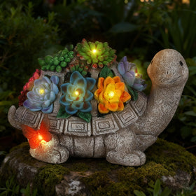 Wanderroot solar garden turtle figurine glowing at dusk beside succulents.