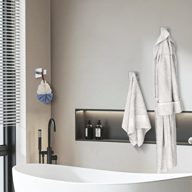 Warlve wall-mounted towel hook holding a towel in a contemporary bathroom.