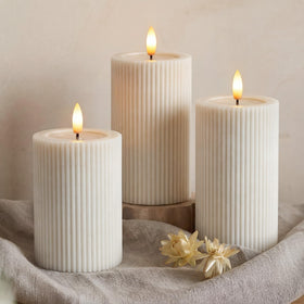 West Ivory fluted ribbed LED pillar candle 5-inch enhances centerpieces with safe glow.