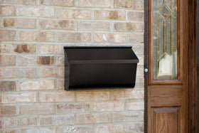 Woodlands textured black wall mailbox side view highlights slim space-saving wall installation