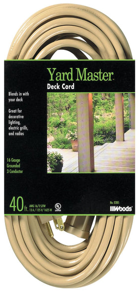 Woods Yard Master extension cord laid out beside outdoor gear for yard work and powering tools.
