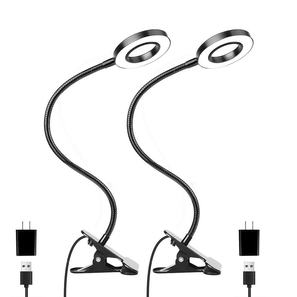 Woputne desk clip-on lamp lighting a bedside reading setup with a warm glow