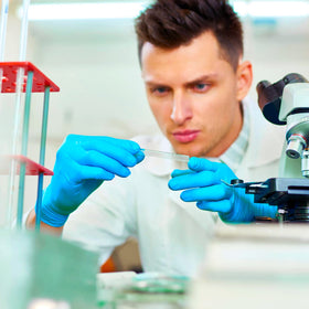 Wostar nitrile gloves in lab setup for precise handling.