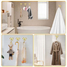 XHIPY gold bow wall hook in bathroom for towels and robes.