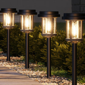 XMCOSY+ solar pathway lights 6-pack illuminate a yard path with warm glow.