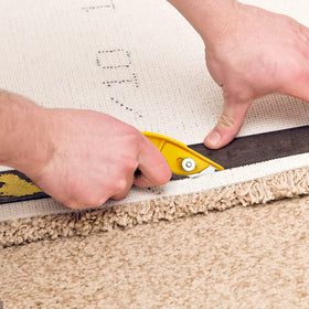 XW light knife storing a carpet blade inside its handle for easy reach