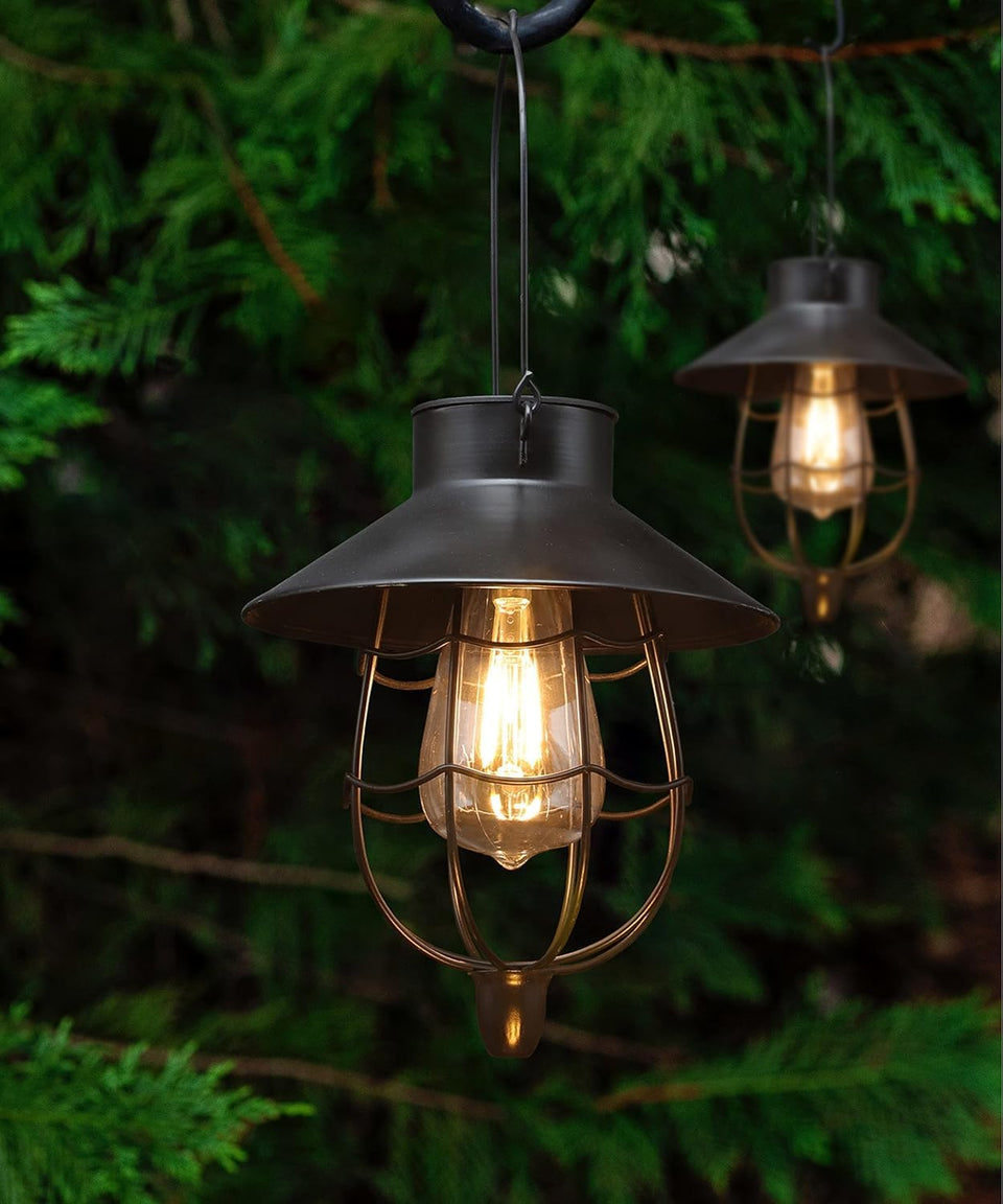 YAKii 2-pack solar lanterns hang on a black hook, creating inviting front-yard ambience.