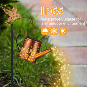 Yamodoor watering-can lantern glows softly using solar power.